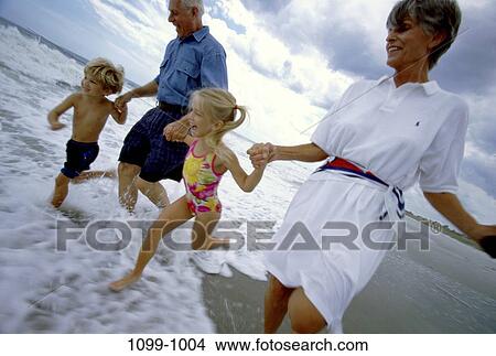 people, running, beach, lifestyles, holding hands, grandparents, summer vacation View Large Photo Image Picture - people, running, beach, lifestyles, holding hands, grandparents, summer vacation. Fotosearch