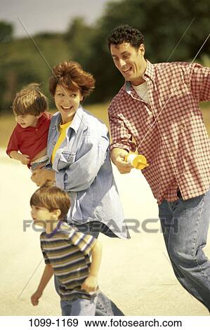 Stock Photo - people, running, flying, laughing, outdoors, adventurous, family. Fotosearch