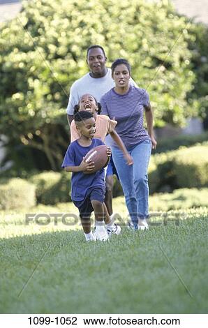 people, running, playing, racing, football, outdoors, family View Large Photo Image Stock Image - people, running, playing, racing, football, outdoors, family. Fotosearch