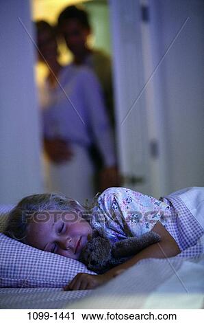Stock Image - people, sleeping, mother, bed, tranquility, nurturing, family. Fotosearch