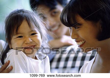 people, smiling, Asian, sitting, mother, laughing, holding View Large Photo Image Stock Photo - people, smiling, Asian, sitting, mother, laughing, holding. Fotosearch