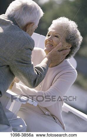 people, smiling, coat, couple, sitting, senior, sweater View Large Photo Image Stock Image - people, smiling, coat, couple, sitting, senior, sweater. Fotosearch