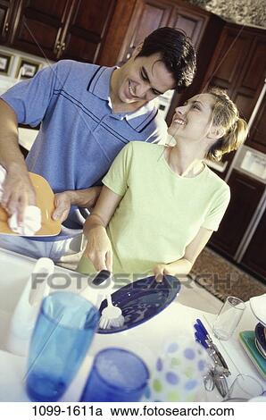 people, smiling, couple, happy, cleaning, smile, kitchen View Large Photo Image Stock Image - people, smiling, couple, happy, cleaning, smile, kitchen. Fotosearch
