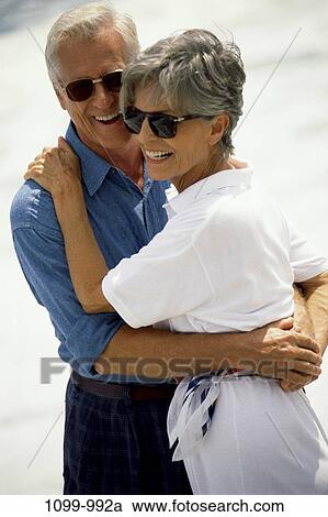 Stock Image - people, smiling, couple, senior, beach, laughing, sunglasses. Fotosearch