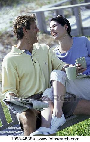 people, smiling, couple, sitting, laughing, outdoors, Middle-aged View Large Photo Image Stock Image - people, smiling, couple, sitting, laughing, outdoors, Middle-aged. Fotosearch