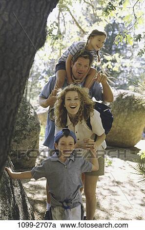 people, smiling, hat, backpack, pointing, trees, outdoors View Large Photo Image Stock Image - people, smiling, hat, backpack, pointing, trees, outdoors. Fotosearch