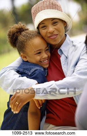 people, smiling, hat, mother, outdoors, hugging, cap View Large Photo Image Stock Image - people, smiling, hat, mother, outdoors, hugging, cap. Fotosearch