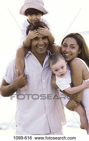 people, smiling, hat, riding, outdoors, carrying, family View Large Photo Image Stock Photograph - people, smiling, hat, riding, outdoors, carrying, family. Fotosearch