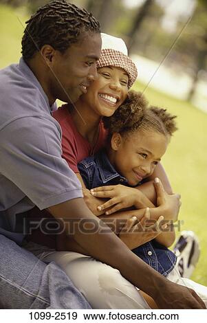 people, smiling, hat, sitting, outdoors, hugging, unity View Large Photo Image Stock Photo - people, smiling, hat, sitting, outdoors, hugging, unity. Fotosearch