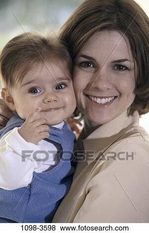 Stock Photo - people, smiling, mother, baby, holding, outdoors, smile. Fotosearch
