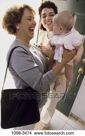 Picture - people, smiling, mother, Hispanic, laughing, holding, three. Fotosearch