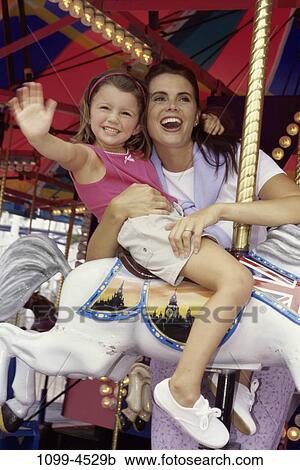 people, smiling, mother, riding, outdoors, amusement, entertainment View Large Photo Image Stock Image - people, smiling, mother, riding, outdoors, amusement, entertainment. Fotosearch