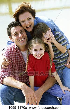 people, smiling, outdoors, hugging, smile, family, kneeling View Large Photo Image Stock Image - people, smiling, outdoors, hugging, smile, family, kneeling. Fotosearch