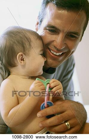 Stock Image - people, smiling, playing, baby, holding, family, affection. Fotosearch