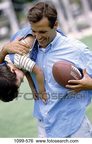 people, smiling, playing, football, playful, outdoors, carrying View Large Photo Image Stock Photograph - people, smiling, playing, football, playful, outdoors, carrying. Fotosearch