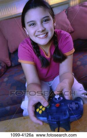 Stock Image - people, smiling, playing, happy, couch, girl, smile. Fotosearch