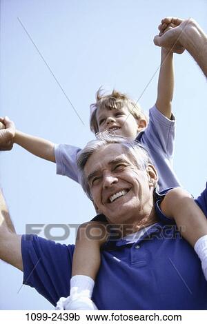 Stock Image - people, smiling, playing, holding, playful, outdoors, carrying. Fotosearch