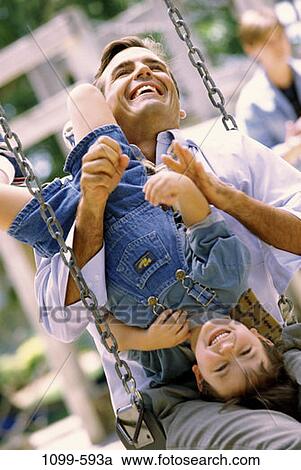 people, smiling, playing, laughing, swinging, swing, playful View Large Photo Image Stock Image - people, smiling, playing, laughing, swinging, swing, playful. Fotosearch