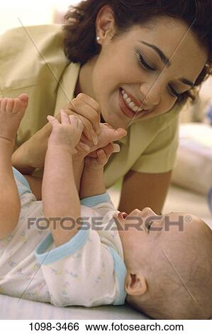 people, smiling, playing, mother, baby, smile, family View Large Photo Image Stock Photograph - people, smiling, playing, mother, baby, smile, family. Fotosearch