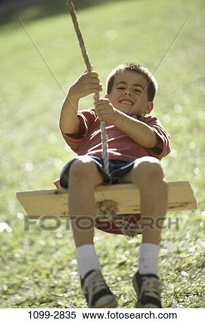 Stock Photography - people, smiling, rope, playing, shorts, swinging, holding. Fotosearch