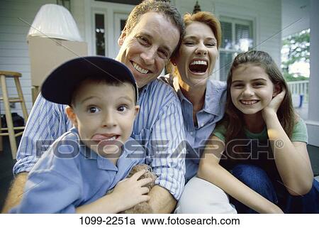 people, smiling, sitting, laughing, playful, tongue, outdoors View Large Photo Image Stock Image - people, smiling, sitting, laughing, playful, tongue, outdoors. Fotosearch