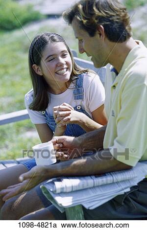 people, smiling, talking, conversation, coffee, bench, outdoors View Large Photo Image Stock Image - people, smiling, talking, conversation, coffee, bench, outdoors. Fotosearch