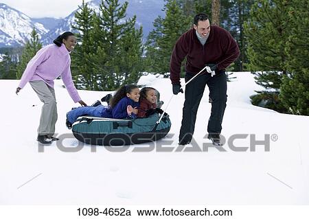 people, snow, winter, pine, inner tube, mountains, trees View Large Photo Image Stock Image - people, snow, winter, pine, inner tube, mountains, trees. Fotosearch