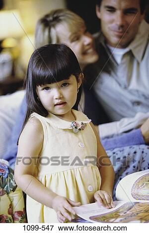 people, staring, book, curious, family, daughter View Large Photo Image Stock Photo - people, staring, book, curious, family, daughter. Fotosearch