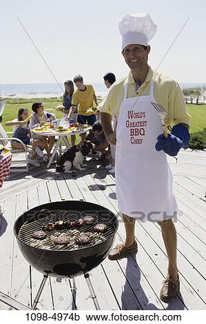 Stock Image - people, table, dog, cooking, pet, outdoors, deck. Fotosearch