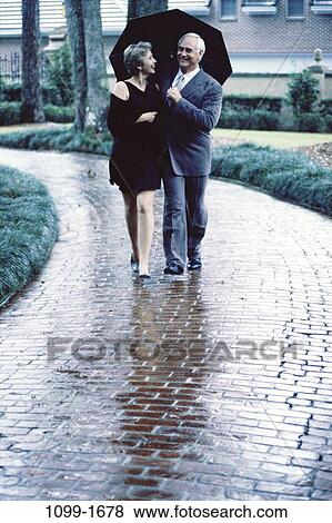 people, umbrella, walking, couple, rain, senior, outdoors View Large Photo Image Stock Photo - people, umbrella, walking, couple, rain, senior, outdoors. Fotosearch