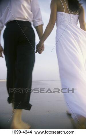 people, walking, couple, beach, holding, barefoot, wedding View Large Photo Image Picture - people, walking, couple, beach, holding, barefoot, wedding. Fotosearch