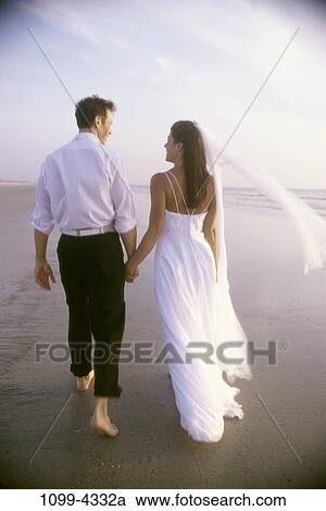people, walking, couple, beach, holding, barefoot, wedding View Large Photo Image Stock Image - people, walking, couple, beach, holding, barefoot, wedding. Fotosearch
