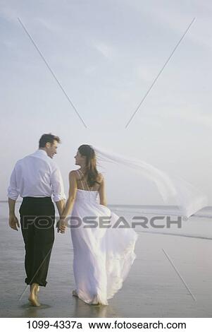 people, walking, couple, beach, billowing, holding, barefoot View Large Photo Image Stock Image - people, walking, couple, beach, billowing, holding, barefoot. Fotosearch