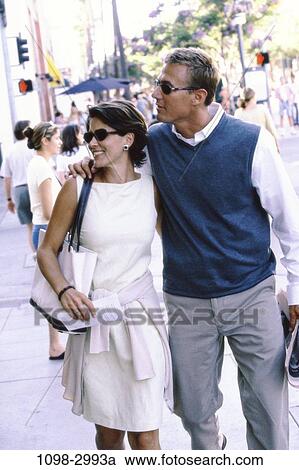 people, walking, couple, sunglasses, street, outdoors, looking View Large Photo Image Stock Image - people, walking, couple, sunglasses, street, outdoors, looking. Fotosearch