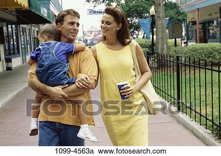 Stock Image - people, walking, talking, outdoors, carrying, family. Fotosearch
