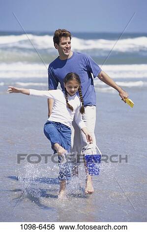 people, water, beach, splash, playful, waves, splashing View Large Photo Image Stock Photograph - people, water, beach, splash, playful, waves, splashing. Fotosearch