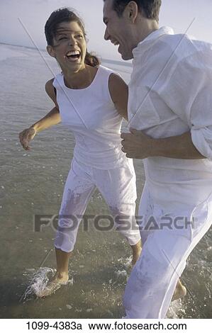 people, water, smiling, walking, couple, beach, laughing View Large Photo Image Stock Image - people, water, smiling, walking, couple, beach, laughing. Fotosearch
