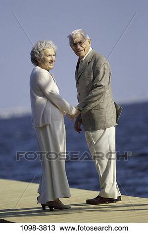 Stock Image - people, water, suit, couple, eyeglasses, senior, holding. Fotosearch