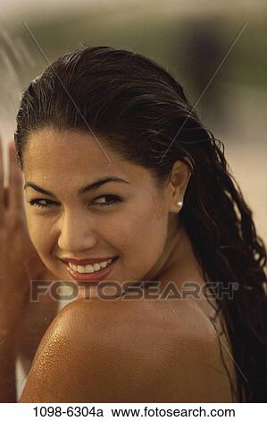 Stock Image - people, water, woman, smiling, staring, Hispanic, watch. Fotosearch