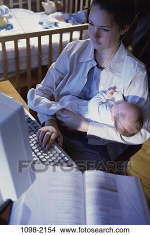 people, woman, baby, computer, typing, holding, girl View Large Photo Image Picture - people, woman, baby, computer, typing, holding, girl. Fotosearch