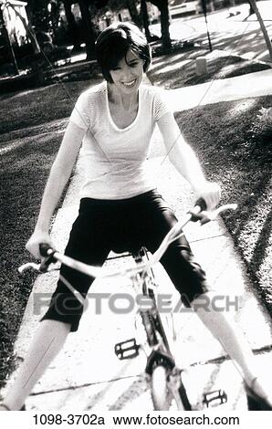 people, woman, bicycle, riding, street, residential, outdoors View Large Photo Image Stock Image - people, woman, bicycle, riding, street, residential, outdoors. Fotosearch