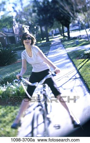 people, woman, bicycle, sunglasses, riding, street, residential View Large Photo Image Stock Image - people, woman, bicycle, sunglasses, riding, street, residential. Fotosearch