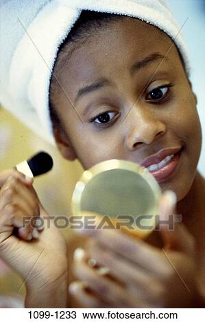 Stock Image - people, woman, mirror, makeup, towel, brush. Fotosearch