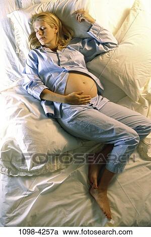 people, woman, sleeping, bed, tranquility, pillows, pajamas View Large Photo Image Stock Image - people, woman, sleeping, bed, tranquility, pillows, pajamas. Fotosearch