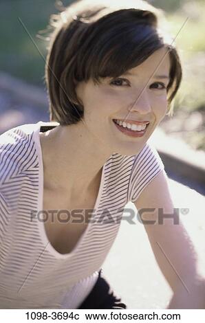 Stock Image - people, woman, smiling, outdoors, smile, posing, brunette. Fotosearch