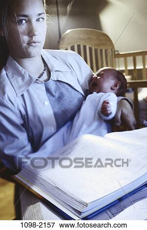 Stock Photo - people, woman, staring, mother, baby, crying, book. Fotosearch