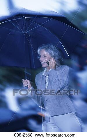 people, woman, telephone, umbrella, walking, talking, rain View Large Photo Image Stock Photo - people, woman, telephone, umbrella, walking, talking, rain. Fotosearch