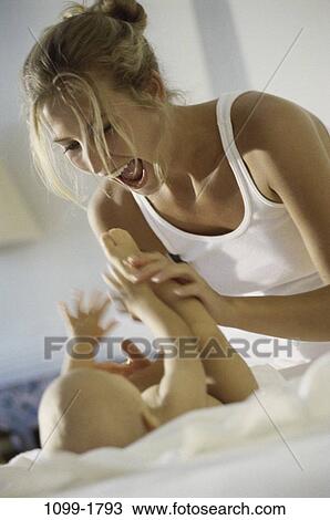 playful, people, baby, mother, playing, family, attentive View Large Photo Image Stock Image - playful, people, baby, mother, playing, family, attentive. Fotosearch