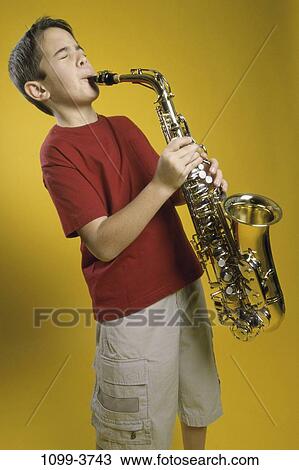 Stock Image - red, people, playing, orange, music, boy, child. Fotosearch