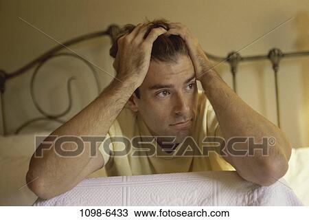 Stock Image - reflection, home, sitting, bed, anxiety. Fotosearch